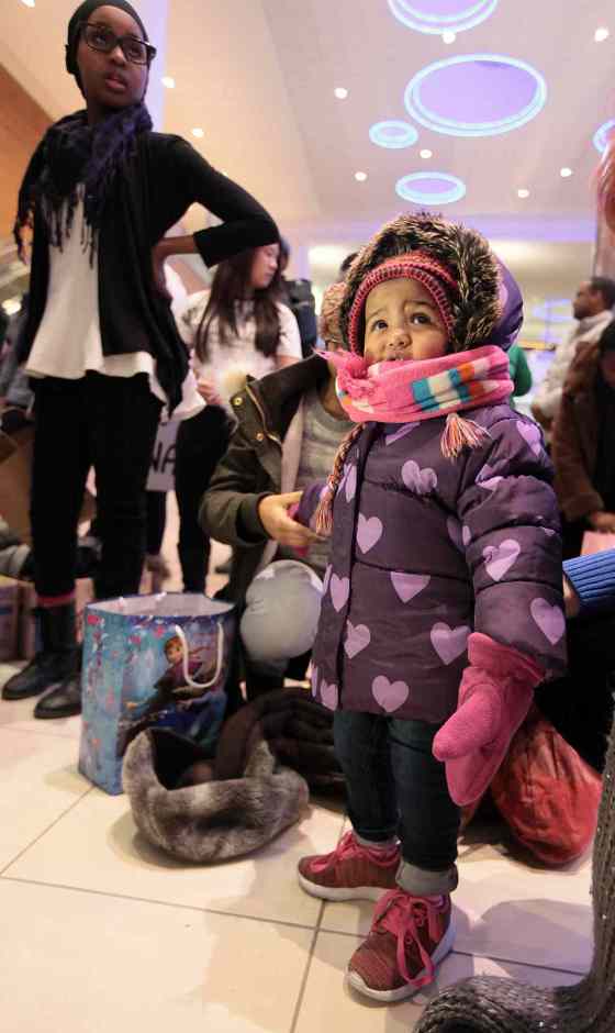 Phil Hossack / Winnipeg Free Press18-month-old Kinda Ismail peers out of a new parka after arriving at the James Richardson International Thursday evening.