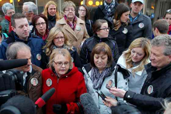 BORIS MINKEVICH / WINNIPEG FREE PRESS The family of Elizabeth Lafantaisie assembles on the steps in front of the Law Courts building following the guilty verdict. In middle of the crowd are the victims' two daughters, Lise Gosselin (in red) and Anna Maynard (in grey).