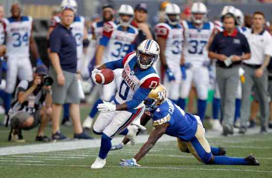 PHIL HOSSACK / WINNIPEG FREE PRESSMontreal Alouettes' Stefan Logan scrambles to escape Winnipeg Blue Bombers' Roc Carmichael in the first half.