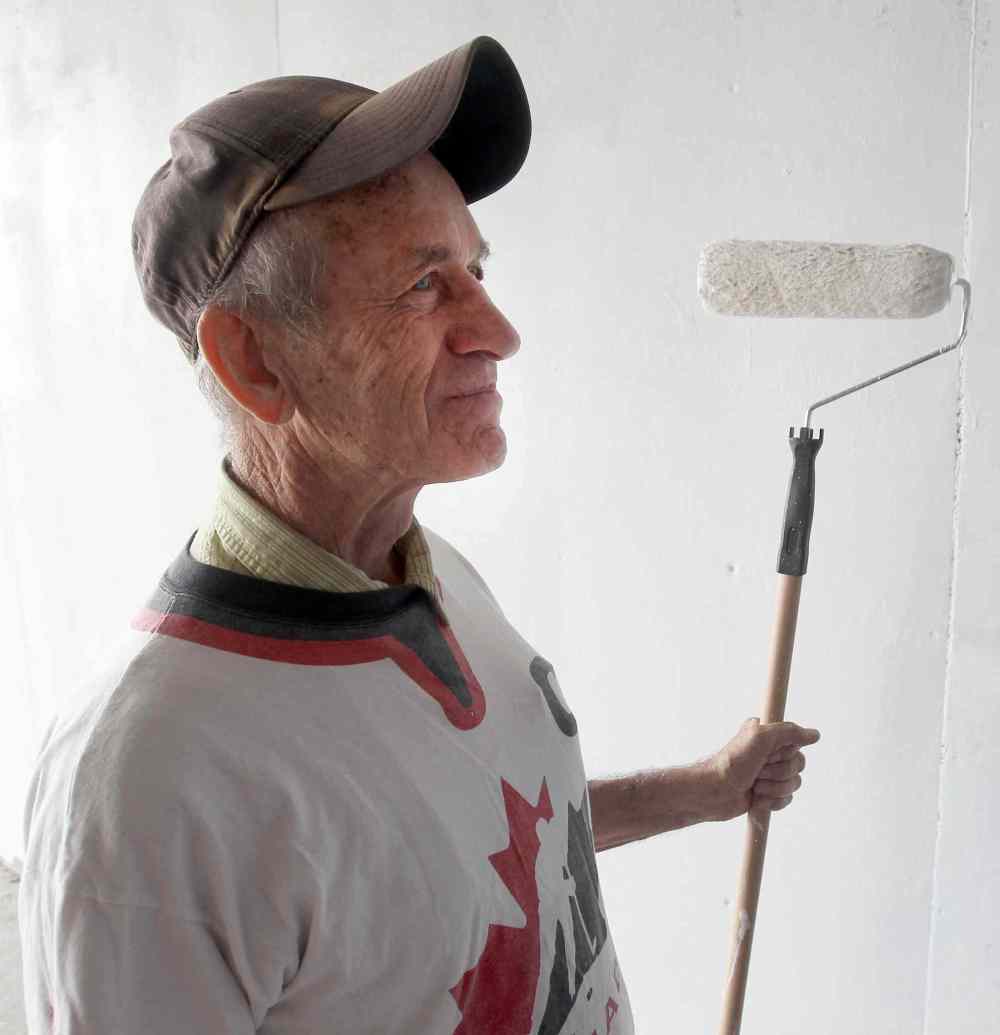 Sel Burrows joins the Point Douglas Residence Committee Green Team that took part in painting the dark underpass near Main Street and Higgins Avenue white to brighten it up. (Joe Bryksa / Winnipeg Free Press)