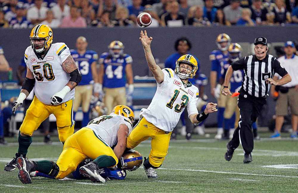PHIL HOSSACK / WINNIPEG FREE PRESS
Edmonton quarterback Mike Reilly goes down throwing as Blue Bomber Jamaal Westerman clings to his ankle in the 3rd quarter, Thursday.