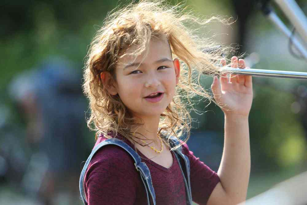 Jersey Siebrecht, 9, performs at Joe Zuken Park in Point Douglas for a fundraising concert called Communities Building Communities. (Ruth Bonneville / Winnipeg Free Press)