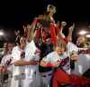Winnipeg Goldeyes players hoist the trophy after winning their second consecutive American League Championship, beating the Wichita Wingnuts by a convincing 18-2 margin Wednesday at Shaw Park in downtown Winnipeg.