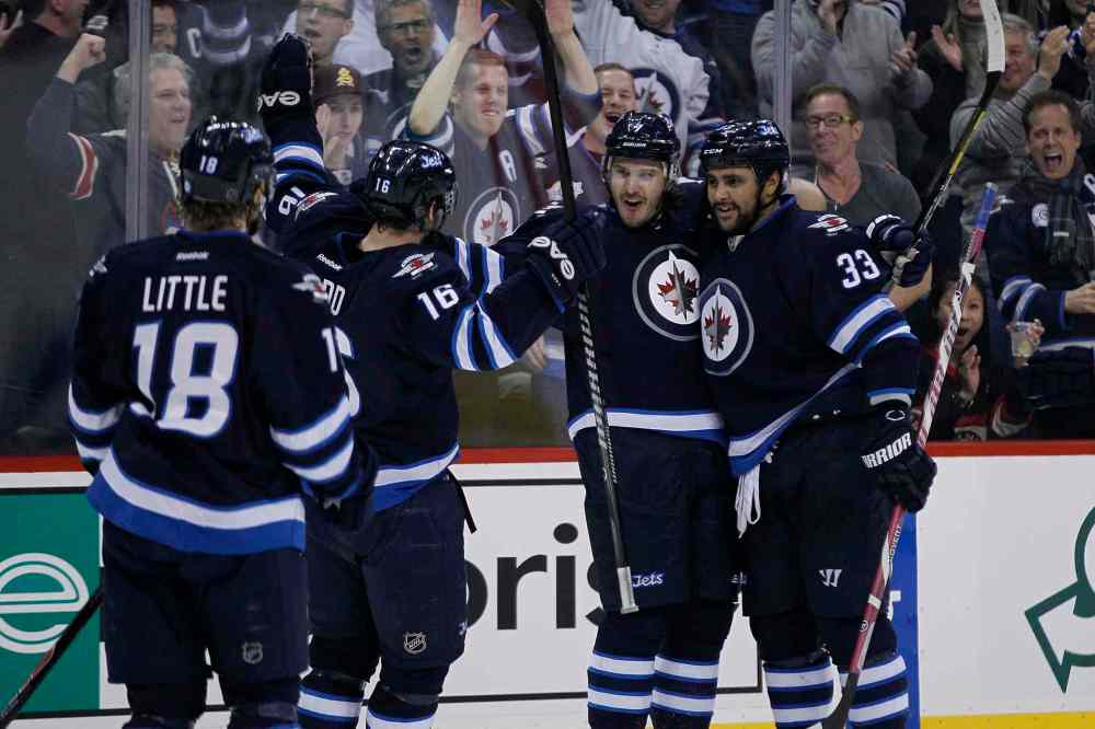 John Woods / the canadian press
Bryan Little, Andrew Ladd (16), Keaton Ellerby and Dustin Byfuglien (33) celebrate Ellerby's goal.