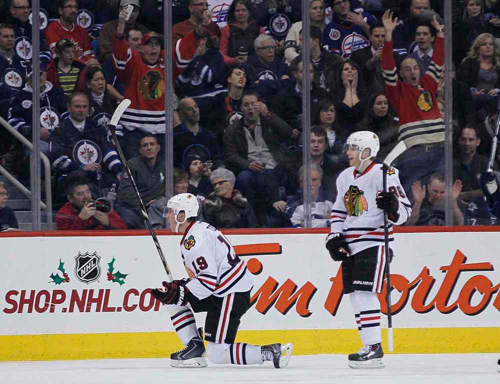 John Woods / the canadian press
Chicago Blackhawks Jonathan Toews (left) and Patrick Kane celebrate Toews' goal. Toews threw in three assists Thursday night for good measure.