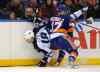 Kathy Kmonicek / The Associated Press
Andrew MacDonald (right) of the New York Islanders shoves Winnipeg Jets forward Bryan Little into the boards in the first period of Wednesday's night's game in Uniondale, N.Y.