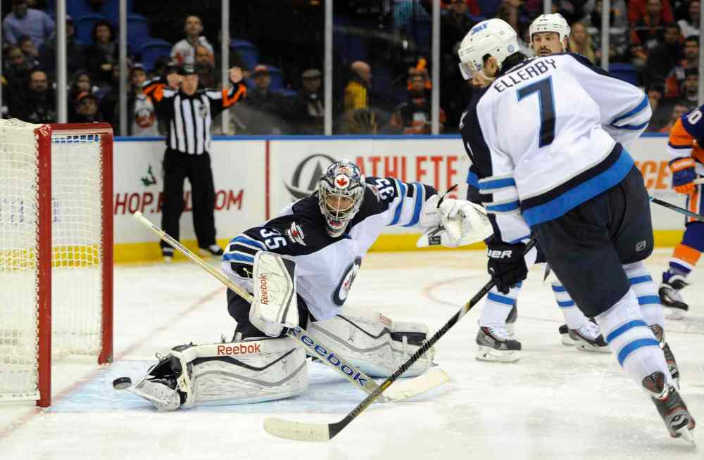 Kathy Kmonicek
Winnipeg Jets goalie Al Montoya kicks the puck away from the goal as Keaton Ellerby defends against the New York Islanders in the second period