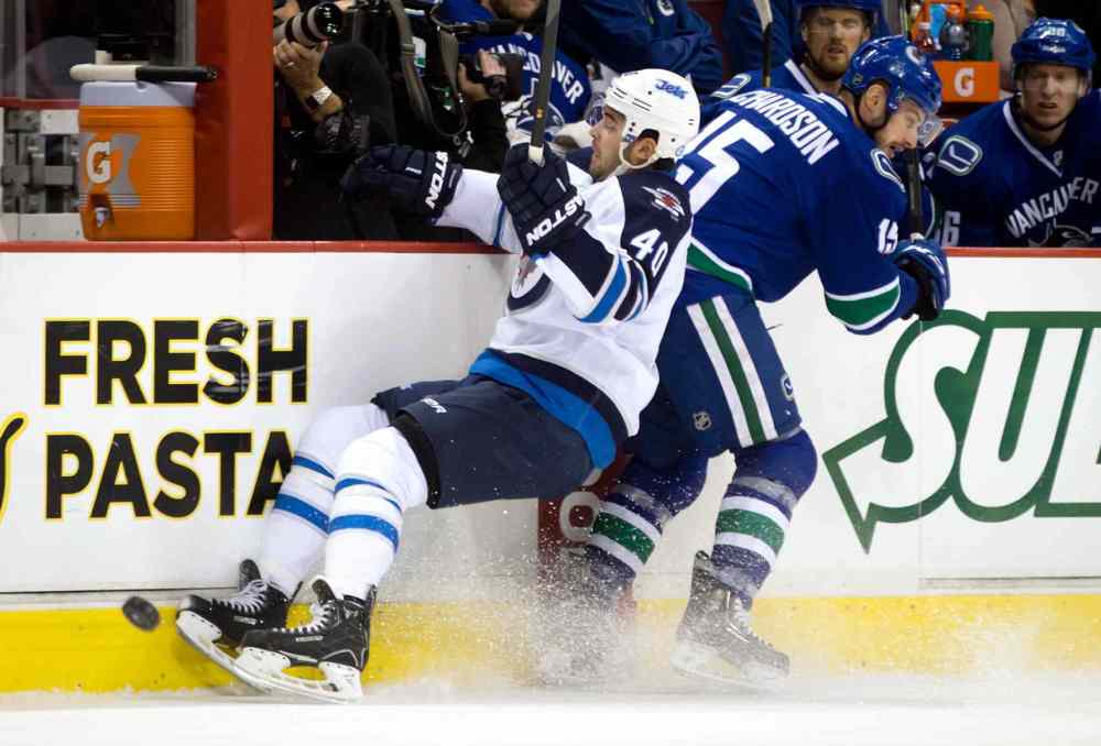 DARRYL DYCK / The Canadian Press
Winnipeg Jets forward Devin Setoguchi (left) and Brad Richardson of the Vancouver Canucks collide during the first period of Sunday's game.