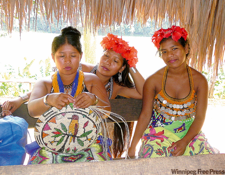 Canwest News Service
The Embera women wear brightly colour sarongs, jewelry and hibiscus flowers in their hair. Some of their income comes from making hand-made crafts like this straw bowl.