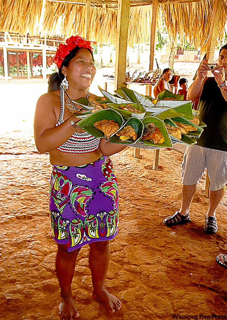 Canwest News Service
A lunch of freshly caught and fried tilapia and fried plantain is served by an Embera woman beneath a thatched-hut roof.