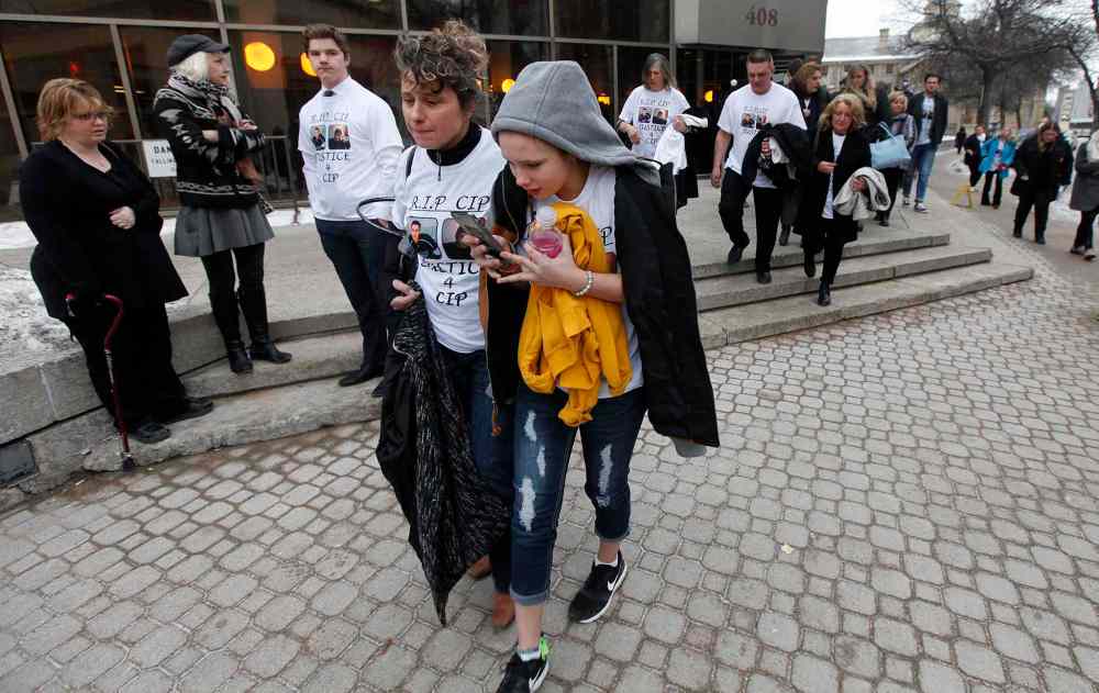PHIL HOSSACK / WINNIPEG FREE PRESS
Cooper Nemeth's mother Gaylene embraces her daughter Kiana (11) as they exit the courthouse.