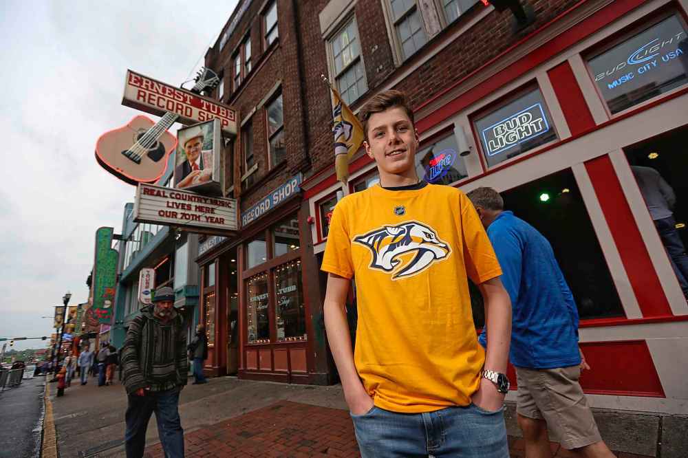 TREVOR HAGAN / WINNIPEG FREE PRESS
Nashville once drew only country music buffs. Now it’s attracting hockey fans like Steven Friedli, 16, of Switzerland, taking a walk down Broadway in downtown Music City Thursday.