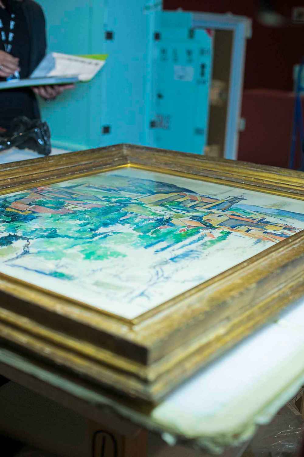 Staff at the Winnipeg Art Gallery uncrate paintings for the new summer exhibition.