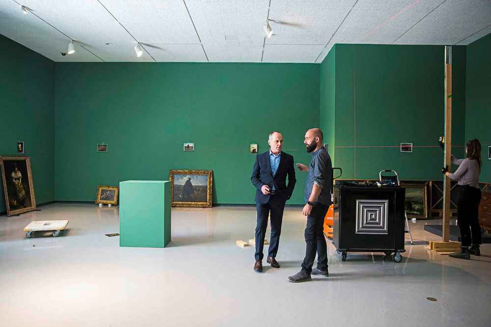 WAG director Stephen Borys (left) and head of museum services Radovan Radulovic discuss the setup of the exhibit.