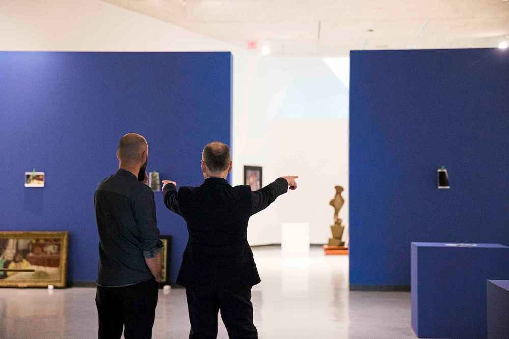 Head of museum services Radovan Radulovic (left) and director of the Winnipeg Art Gallery Stephen Borys tweak the setup of the exhibit.