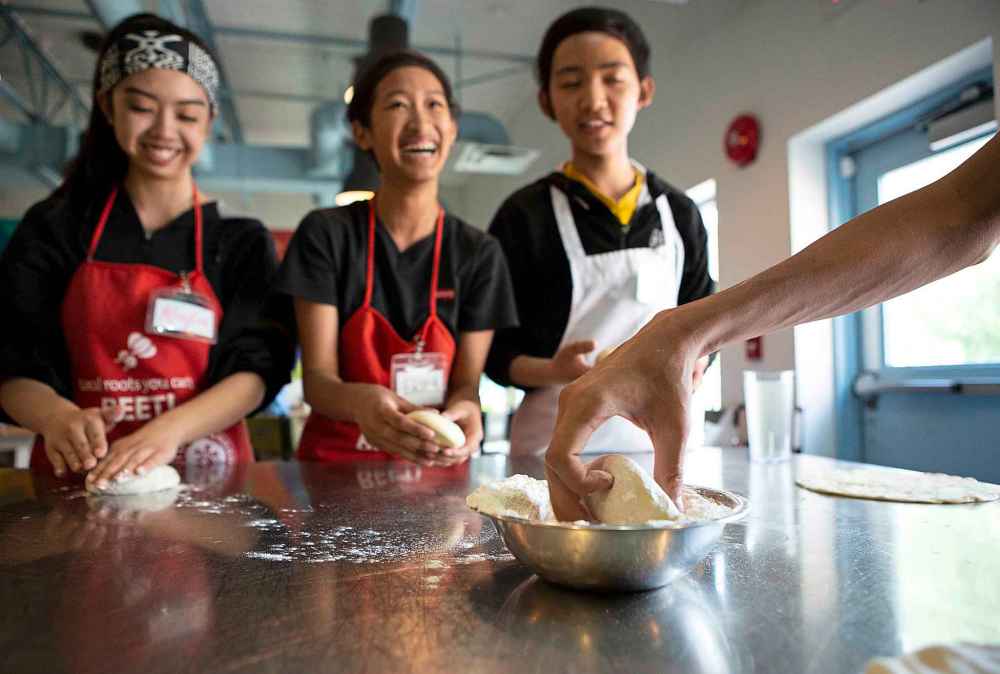 The Winnipeg Free Press
Kayla Umali, left, Erika Yazon, and Winzy Hinsunarin practice kneading pizza dough at the Food Justice Club at the NorWest Co-op Community Food Centre. (Photos by Andrew Ryan / Winnipeg Free Press)
