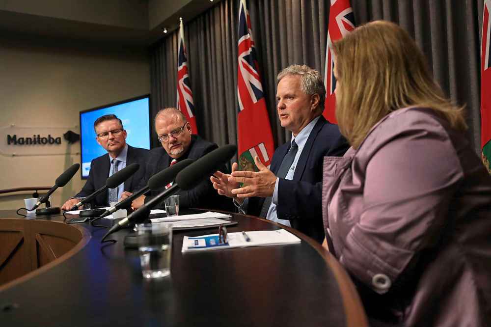 RUTH BONNEVILLE / WINNIPEG FREE PRESS
Dr. Brock Wright, CEO, Shared Health, answers questions from the media about the layout of the Health System Transformation Blueprint with Ian Shaw,, transformation management leader (far left), Health, Minister Kelvin Goertzen, and Ms. Karen Herd, CA Deputy Minister of Health, at the Legislative Building Thursday.