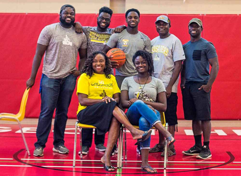 Rising basketball star Daniel Sackey and his family. Top row, from left: Clement Sackey, Desmond Sackey, Daniel Sackey, David Sackey, and Stephen Tackie. Bottom row: Mercy Sackey, Clementina Sackey. (Mikaela MacKenzie)