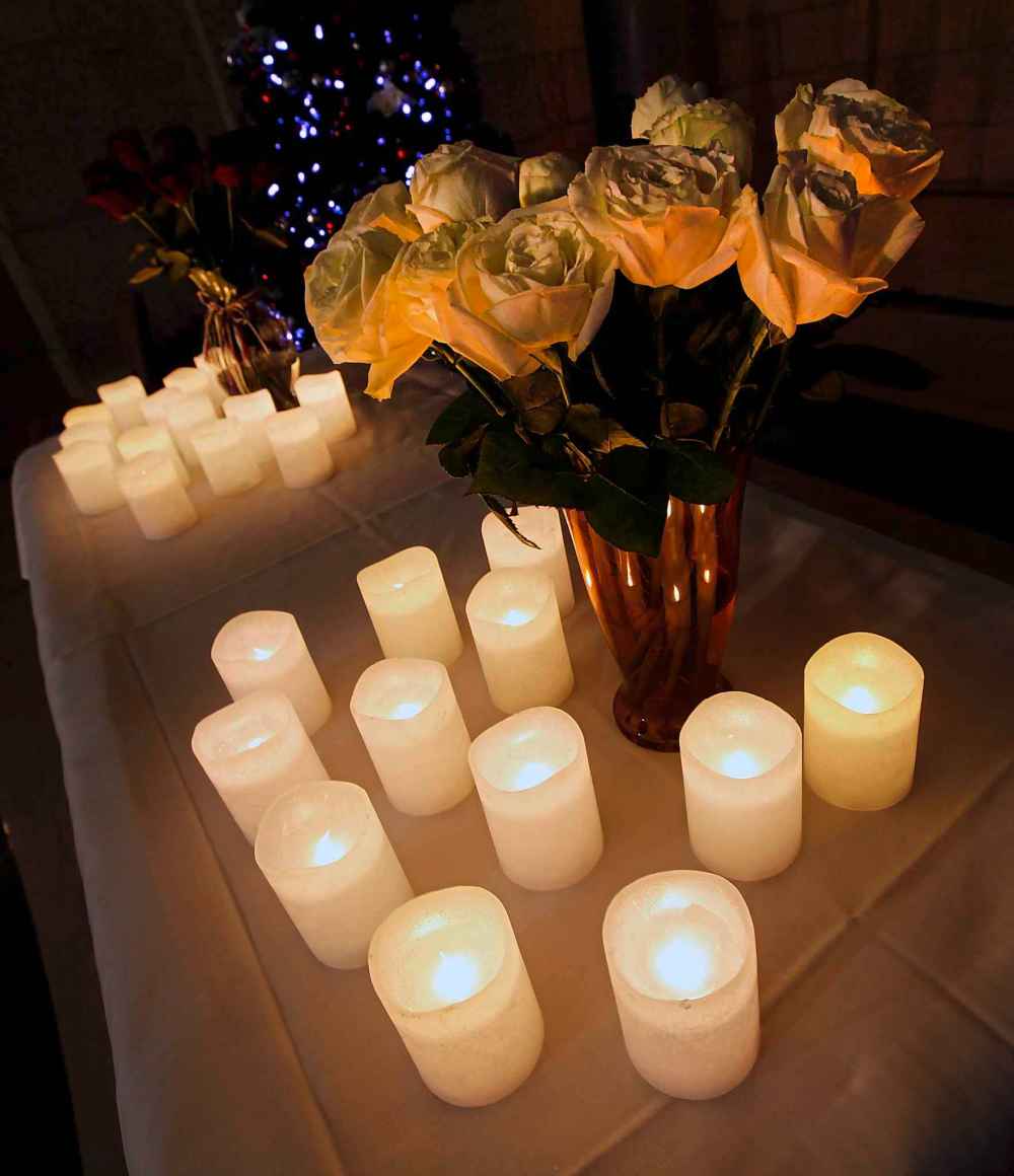 A dozen roses and a dozen candles to mark each of the slain women in Manitoba this year as approximately 100 people gathered at the legislature's rotunda Thursday evening to mark the National Day of Remembrance and Action on Violence Against Women. (Phil Hossack / Winnipeg Free Press)