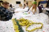 John Woods / Winnipeg Free Press
Volunteers and Tessa Blaikie Whitecloud, executive director of 1JustCity, right, make blankets and sleeping mats out of plastic shopping bags for people living on the streets Sunday. On Tuesday Just a Warm Sleep will open to offer up to 25 people a safe place to sleep.