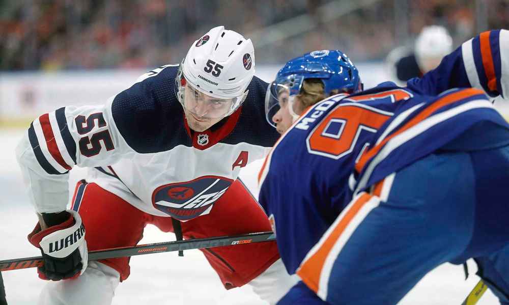 TREVOR HAGAN / WINNIPEG FREE PRESS
Winnipeg Jets' Mark Scheifele (55) and Edmonton Oilers' Connor McDavid (97) during a face-off during the first period.