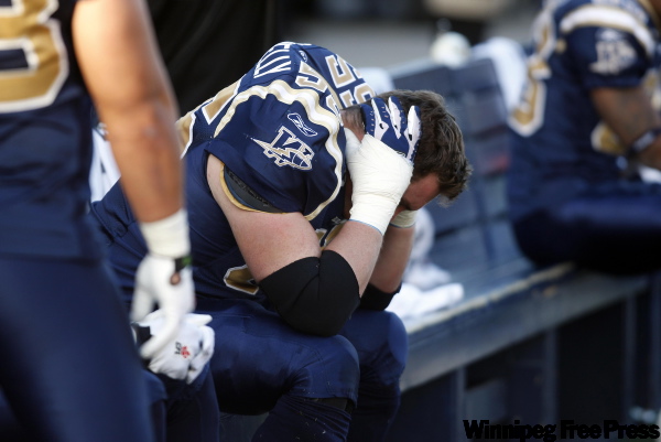 BORIS.MINKEVICH@FREEPRESS.MB.CA
Winnipeg Blue Bombers Ryan Donnelly sits dejected on the bench after the team lost 39-17 to Hamilton, ending the season.