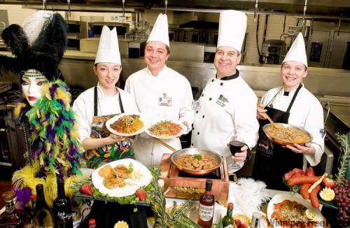 DAVID LIPNOWSKI / WINNIPEG FREE PRESS
Cook’s helper Jillian Ferguson (from left) Garde Manger cook Greg Bilyk, Harty and Garde Manger cook Amy Faschauner have an array of Mardi Gras tastes ready for diners.