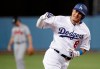 FILE - In this Oct. 5, 2018, file photo, then-Los Angeles Dodgers' Manny Machado celebrates his two-run home run against the Atlanta Braves during the first inning of Game 2 of a baseball National League Division Series, in Los Angeles. A person familiar with the negotiations tells The Associated Press that infielder Manny Machado has agreed to a $300 million, 10-year deal with the rebuilding San Diego Padres, the biggest contract ever for a free agent. The person spoke to the AP on condition of anonymity Tuesday, Feb. 19, 2019, because the agreement was subject to a successful physical and had not been announced. (AP Photo/Jae C. Hong, File)