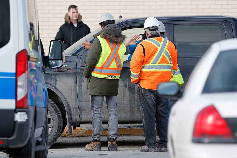Workplace Health and Safety officials talk to a driver as they investigate at the scene of a fatal pedestrian/truck collision in the Garden City Shopping Centre parking lot in April.
JOHN WOODS / WINNIPEG FREE PRESS FILES