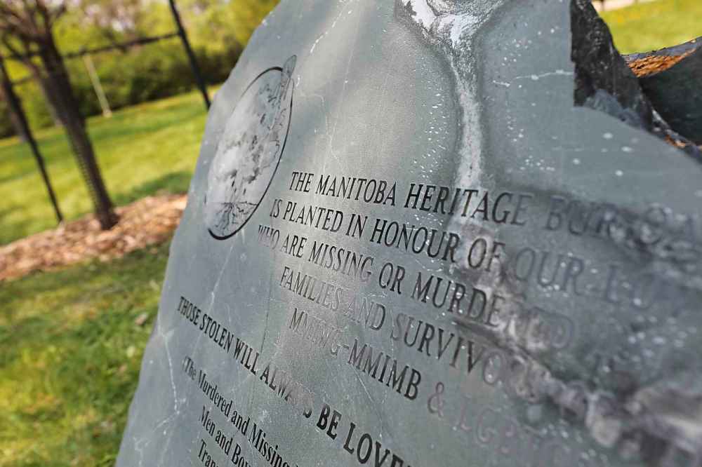 RUTH BONNEVILLE / WINNIPEG FREE PRESS
Graham covered a commemorative stone with a blanket that belonged to her sister before it was unveiled.