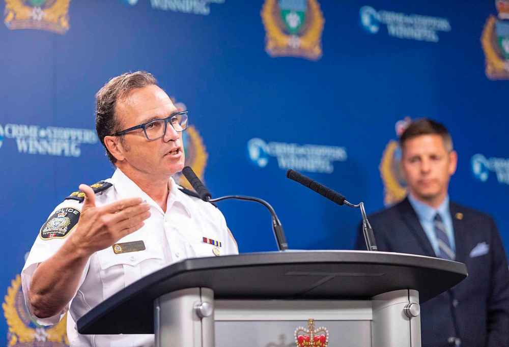 Winnipeg Police Chief Danny Smyth (left) and Mayor Brian Bowman present the Police Service's Annual Statistical Report during a media briefing at Police Headquarters in July 2019. The mayor has requested a meeting with Premier Brian Pallister and Prime Minster Justin Trudeau to find solutions to Winnipeg's current crime crisis. (Sasha Sefter / Winnipeg Free Press files)