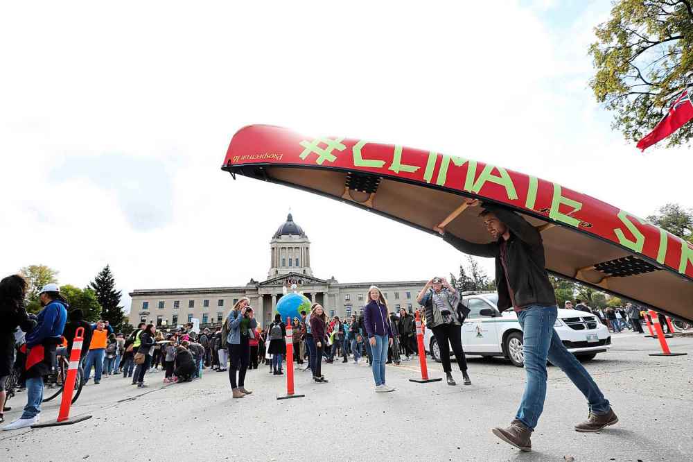 “Everyone’s here demonstrating and here I am carrying the canoe, and I thought there was a bit of symmetry and symbolism. The portage is often the hardest part [of a canoe trip],” said Garrett Tremblay. (Ruth Bonneville / Winnipeg Free Press)