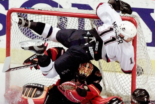 Vancouver’s Mark Messier slams into the post after scoring a goal against Calgary in this 1998 photo. Messier sustained a concussion on the play.
