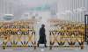 The Associated Press
A South Korean Army soldier walks on Unification Bridge in Paju, South Korea, near the border village of Panmunjom, Saturday. More South Koreans on Saturday began to leave North Korea and the factory park where they work, four days after Pyongyang closed the border to people and goods.