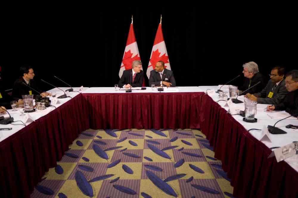 Brett Gundlock/ National Post
Canada's Prime Minister Stephen Harper, centre left, and Canadian Senator Don Meredith talk the ethnic media at a round table in 2011.
