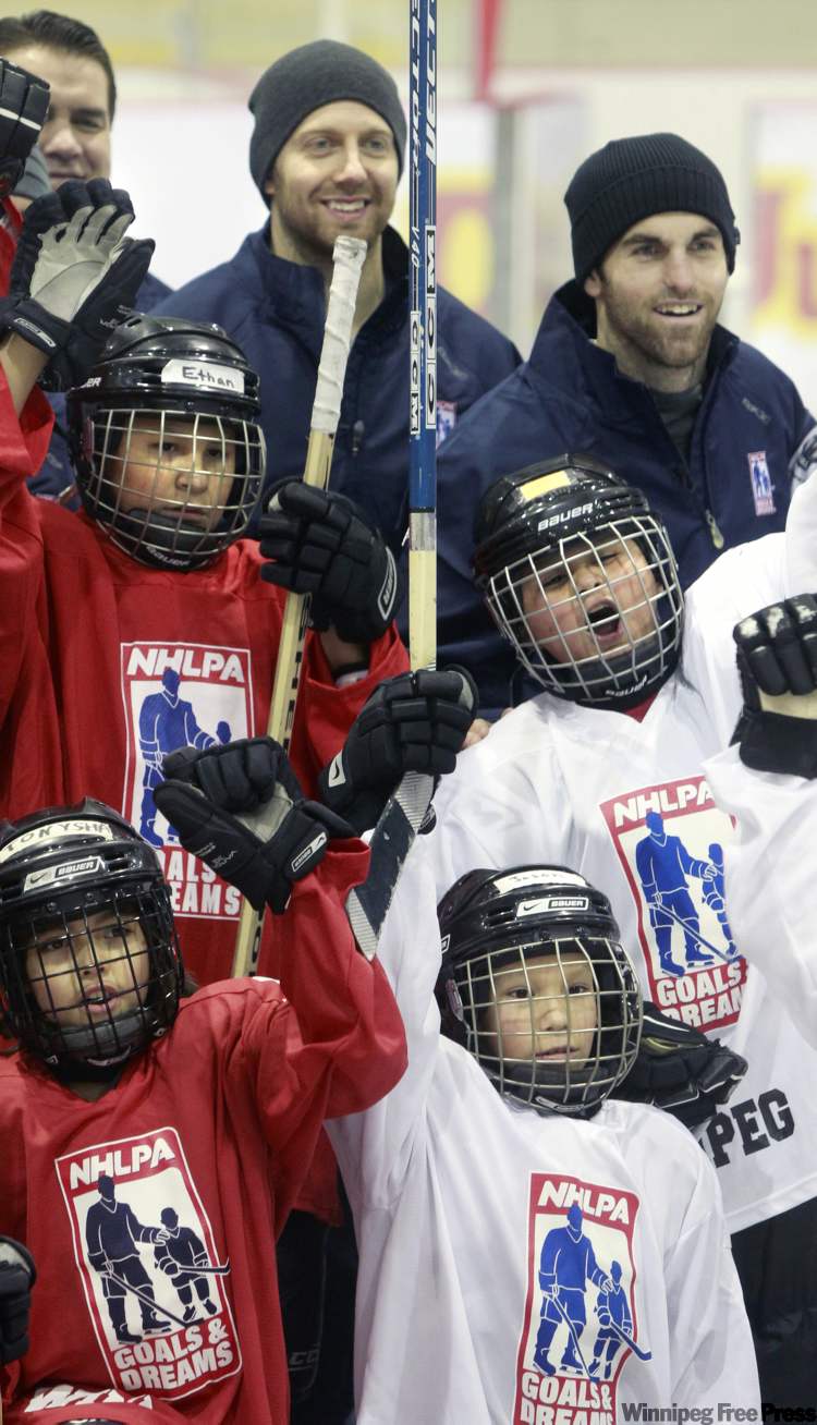 WAYNE GLOWACKI / WINNIPEG FREE PRESS
Winnipeg Jets players Andrew Ladd (top right) and Eric Fehr (top centre) gave the kids lots of pro tips and had fun doing it on Thursday at the MTS IcePlex.