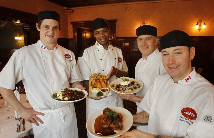 Wayne Glowacki / Winnipeg Free Press
From left, 529 Wellington's sous-chef Martin Philippe with sauteed beef tenderloin, first cook Delroy Clarke with fried pickerel and chips, sous chef Thomas Revoy with blueberry bread pudding for two and first cook Adam Buchan with mini-Yorkshires stuffed with prime rib.