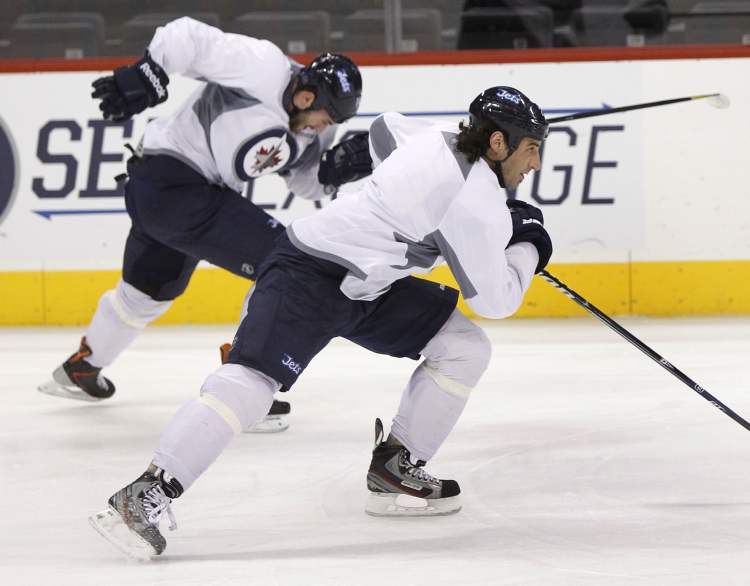 Wayne Glowacki / Winnipeg Free Press
Winnipeg Jets wingers Chris Thorburn (right) and Anthony Peluso churn through a skating drill at Wednesday's practice.
