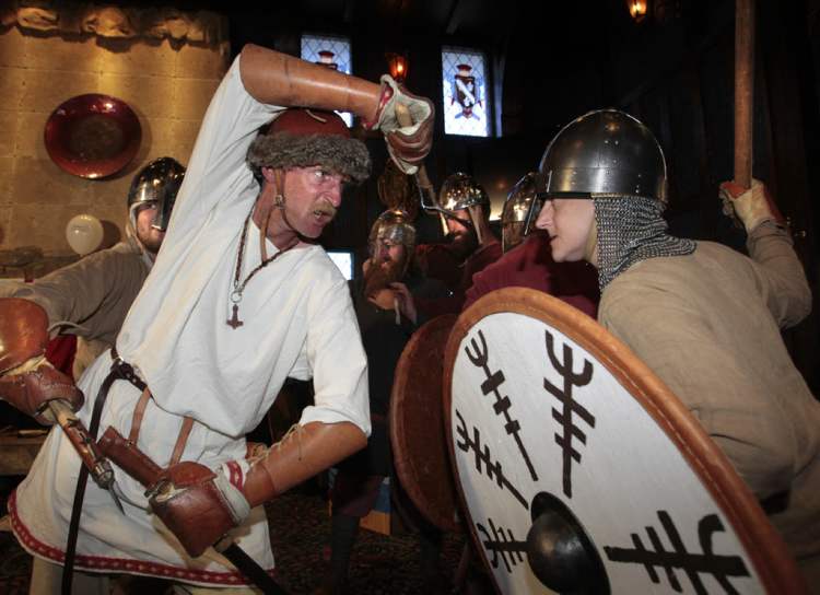 George Scott (left) and Cathy Dyck perform a combat enactment at the Round Table restaurant in Winnipeg to help kick off the 124th Icelandic Festival of Manitoba this weekend in Gimli.