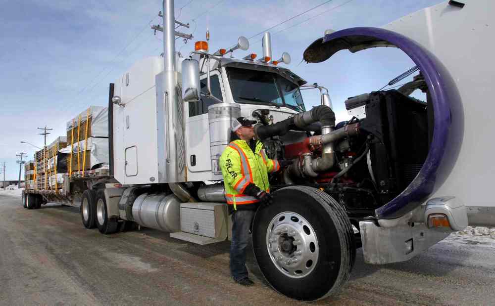 WAYNE GLOWACKI / WINNIPEG FREE PRESS
Trucker Kelly Ring checks his rig in Winnipeg last week before hauling building supplies to Garden Hill First Nation. It's a 1,000-kilometre round trip over treacherous ice roads.