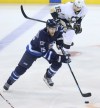Crystal Schick / Winnipeg Free Press
Winnipeg Jet #15 Matt Halischuk, is chased down in first period action by Pittsburgh Penguin #16 Brandon Sutter at the MTS Centre in Winnipeg on Thursday, April 3, 2014.