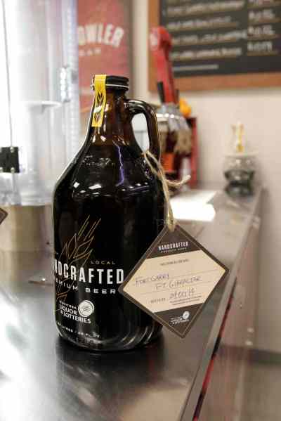 WAYNE GLOWACKI / WINNIPEG FREE PRESS
The 1.89-litre refillable Growler a customer can purchase is filled by a staff person with a craft beer.