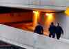 Wayne Glowacki / Winnipeg Free Press
Police officers walk up the ramp of a downtown parkade on Hargrave Street after a teenage foster child was severely hurt. The attack took place early Wednesday morning.