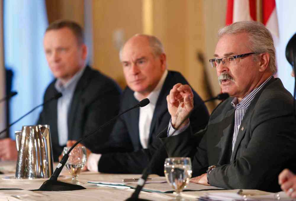 WAYNE GLOWACKI / WINNIPEG FREE PRESS
From right: Agriculture Minister Gerry Ritz, Ian White of the Canadian Wheat Board and Karl Gerrand, president and CEO of G3 speak in Winnipeg Wednesday on the commercialization process for the CWB.