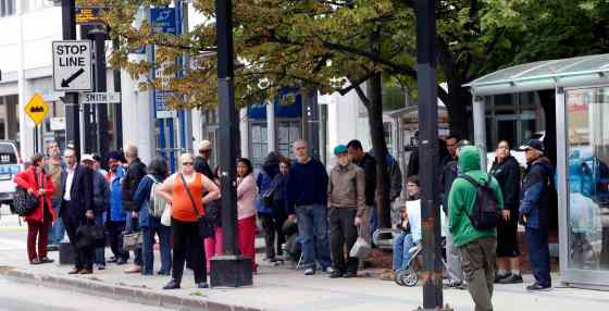 Riders wait at the bus stop on Graham Avenue at Smith Street Thursday. Winnipeggers will have to get used to a reduced level of Transit service as the department struggles with a manpower shortage and problematic buses. (Wayne Glowacki / Winnipeg Free Press September)