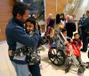 Wayne Glowacki / Winnipeg Free Press
Young Mohammed Abdullah hugs his uncle Kamal who was one of the 24 Syrians that arrived at Richardson International Airport this afternoon. At right in the wheelchair is Mohammed's cousin Omar,14.