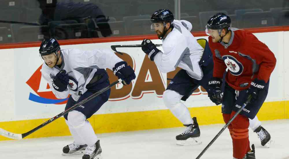 Wayne Glowacki / Winnipeg Free Press
Winnipeg Jets Captain Andrew Ladd (centre) with his line mate Bryan Little at left and defenceman Paul Postma at right at team practice in the MTS Centre Wednesday in preparation for the season opener in Boston on Thursday.