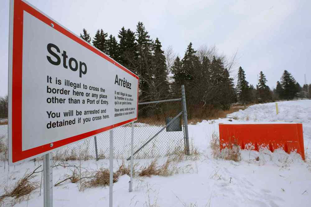 WAYNE GLOWACKI / WINNIPEG FREE PRESS
Signage in Canada just metres from the U.S. border.