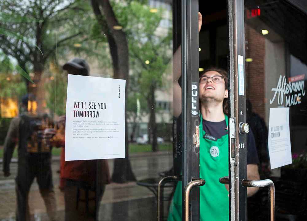 The Winnipeg Free Press
ANDREW RYAN / WINNIPEG FREE PRESS A Starbucks employee locks the door at 2:30 p.m. after the last customers left the location on Broadway. The early closure is part of a continent-wide shut down after a racially insensitive incident drew international attention and prompted racial sensitivity training on June 11, 2018.