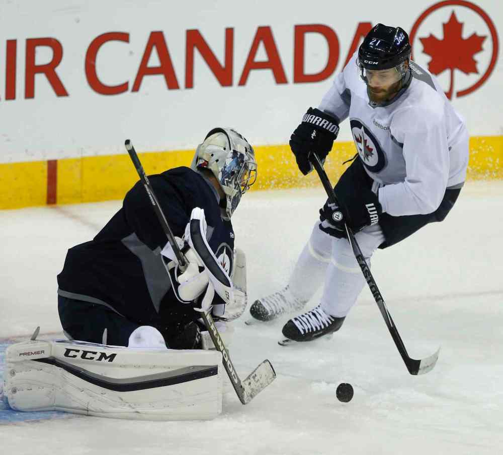 Wayne Glowacki / Winnipeg Free Press
Thomas Raffl heads toward goaltender Ondrej Pavelec this morning at the team practice in the MTS Centre.